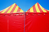 Red And Yellow Circus Tents On Blue Sky