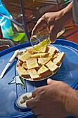 Man Pouring Olive Oil Over Bread