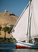 Felucca On River Nile With Tombs Of Nobles And Qubbet El-Hawa Behind