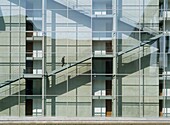 Man Walking Up Stairs In Modern Office Building Beside River Spree