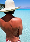 Tourist Wading In Clear Blue Water