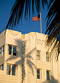 American Flag On Top Of Art Deco Building With Palm Tree Shadow