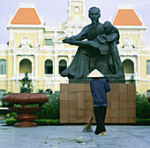 Ho Chi Minh Statue And Woman In Conical Hat Sweeping