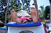 Father And Daughter's Feet On Sun Lounger