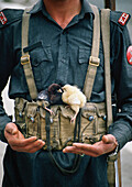 Soldier With Two Chicks Balanced On His Belt