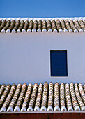 Whitewashed Building With Tiles Roof And Window, Close Up