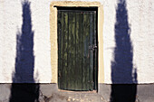 Doorway With Shadows Of Two Trees