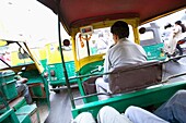 Riding A Rickshaw On A Busy Street