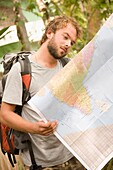 Backpacker Looking At Map Of India