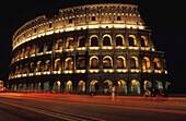 The Colosseum Lit Up At Night With Light Trails Infront