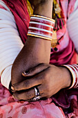 Arms Of Woman In Pink Sari Wearing Jewelry, Close Up