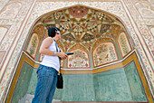 Tourist Listening To Audio Guide In Amber Fort, Low Angle View