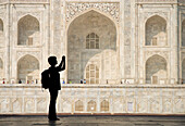 Silhouette Of Woman With Rucksack Photographing The Taj Mahal