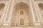 Woman Photographing In Great Arch Of The Taj Mahal At Dawn