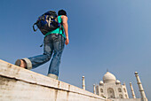 Woman With Rucksack Walking Towards The Taj Mahal, Low Angle View