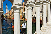 Gondola Riding Along A Peaceful Canal In Venice
