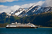 A Cruise Ship Travels Kachemak Bay Leaving Port On The Homer Spit Against A Background Of Snowcapped Kenai Mountains In Kachemak Bay State Park, Southcentral Alaska, Summer