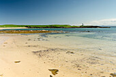 A beach and lighthouse in chapel ness peninsula; Elie east neuk scotland