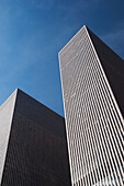 Two skyscrapers against a blue sky; New york city, new york, united states of america