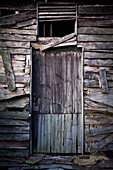 Ruined door of an old chicken coop; Surrey England