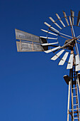 Close Up Of A Windmill Against A Blue Sky; Klein-Aus Vista, Namibia