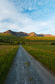 Looking Up A Road Towards The Peaks And Ridges Of The Black Cuillin At Sunset; Isle Of Skye, Scotland