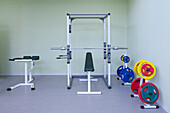 A fitness room, gym equipment, weights and fitness and sports training equipment, in a school. 