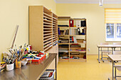 Ein Kunstraum in einer Schule, Klassenzimmer mit Regalen und Geräten, Farben und Pinseln.