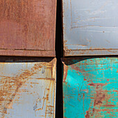 Marks and rust patterns on metal containers, close up. 