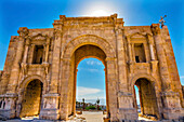 Hadrian's Arch Gate Sun Ancient Roman City Jerash, Jordan. Jerash came to power 300 BC to 100 AD and was a city through 600 AD. Not conquered until 1112 AD by Crusaders. Famous Trading Center. Most original Roman City in the Middle East.