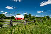 Canada, Ontario, Limoges. Red barn and wooden fence