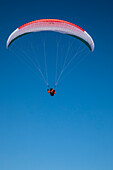 Europe, Austria, Dachstein, Paraglider soaring above Lake Hallstatt and the surrounding mountains, all of which is part of the Salzkammergut Cultural Landscape, UNESCO World Heritage Site