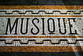 Belgium, Bruges. Music shop street mosaic