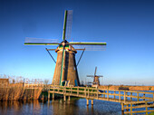 Netherlands, Kinderdijk, Sunrise along the canal with Windmills