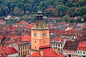 Brasov, Romania. Rooftops and city from hilltop. Clock tower.