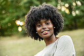 Portrait of smiling young woman in park