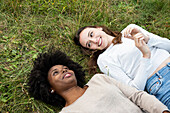Smiling young female friends lying in park
