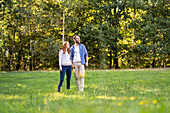 Smiling young couple enjoying a stroll in a park
