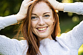 Portrait of smiling young woman in park