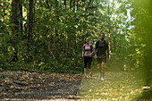 Smiling young couple walking in forest