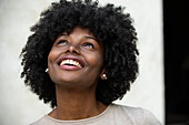 Smiling young woman looking up in park