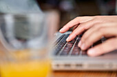 Close-up shot of woman's hands typing on laptop computer