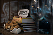 Detail of restaurant decoration with books, signs, corks and wine glass on table