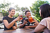 Diverse group of friends hanging out drinking beer at happy hour