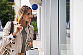 Mid shot of woman looking at shop window