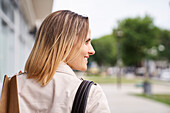 Mid-shot sideview of woman's face walking in the street