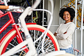 Mittelaufnahme einer afroamerikanischen Ladenbesitzerin in ihrem Geschäft mit Fahrrädern