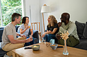 Two diverse couples enjoying a conversation at home