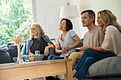 Portrait of diverse group of friends gathered at home to watch a movie