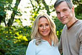 Portrait of middle-aged heterosexual couple posing outdoors